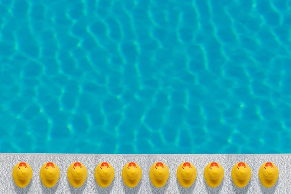 Gele rubberen eenden in de buurt van het zwembad. Zomer minimal concept. — Stockfoto