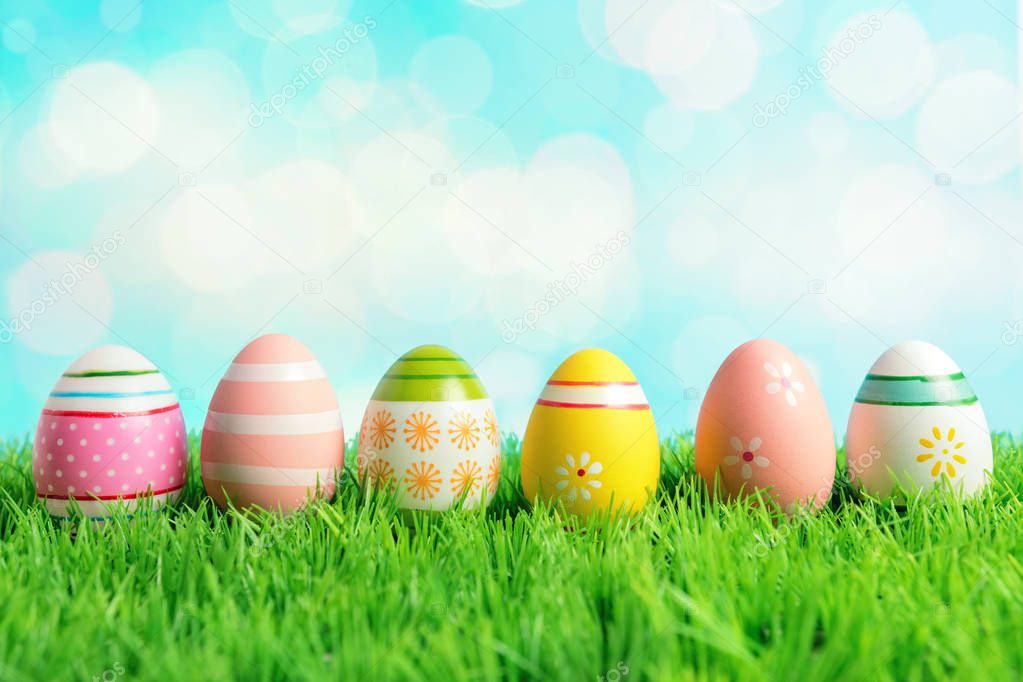 Colorful Easter eggs on green grass. Spring holidays concept.
