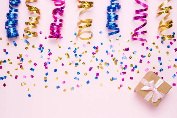 Kleurrijke viering achtergrond met verschillende partij confetti en geschenkdoos. Minimale partij concept. Vlakke lay. — Stockfoto