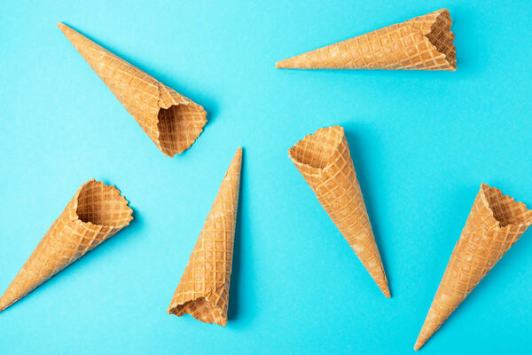 Various ice cream cones on blue background. Minimal summer concept.