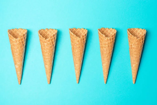 Various ice cream cones on blue background. Minimal summer concept. — Stock Photo, Image