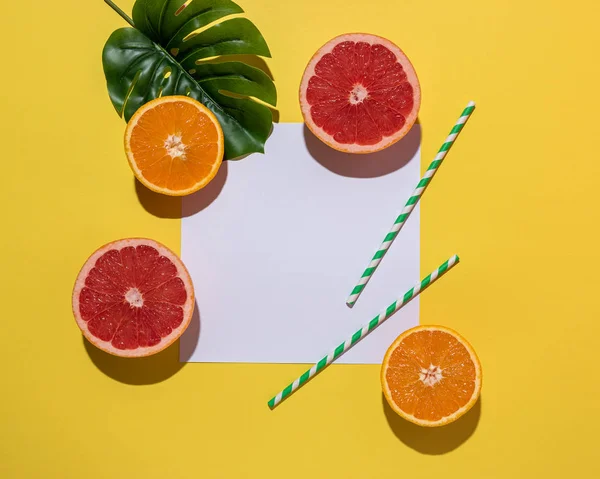 Creative fruit composition on yellow background with hard shadows.