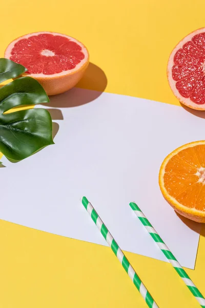 Creative fruit composition on yellow background with hard shadows