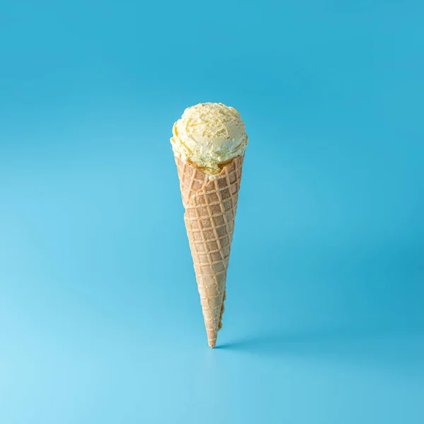 Ice cream scoop with ice cream cone on bright background. — Stock Photo, Image