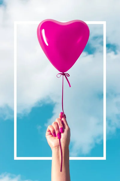 Womans Hand With Heart Shaped Balloon On Background Of Sky Love Concept Old Celebration Stock Photo