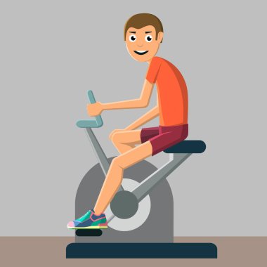 Genç adam eğitim sabit bir bisiklet üzerinde çalışmaktadır.