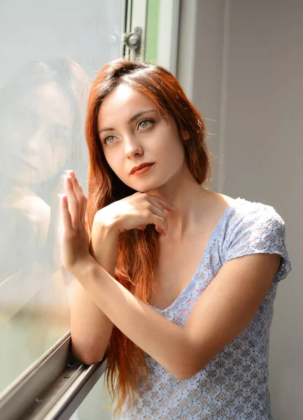 Redhead Girl Looking Through The Window Worried Woman Quarantined Woman Woman Looking Through Window Woman In Love Stock Images Page Everypixel