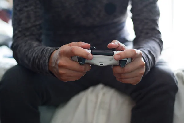 Man playing video games. A man holding a game controller.