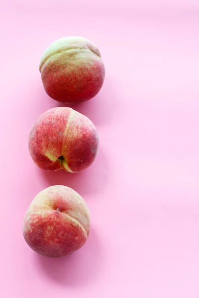 Fresh peaches are on white background.