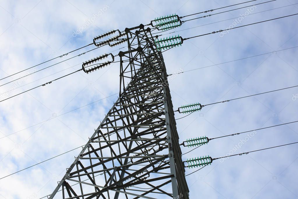 A high voltage tower is under the blue sky