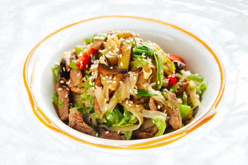 Udon noodles with beef meat and vegetables sesame 