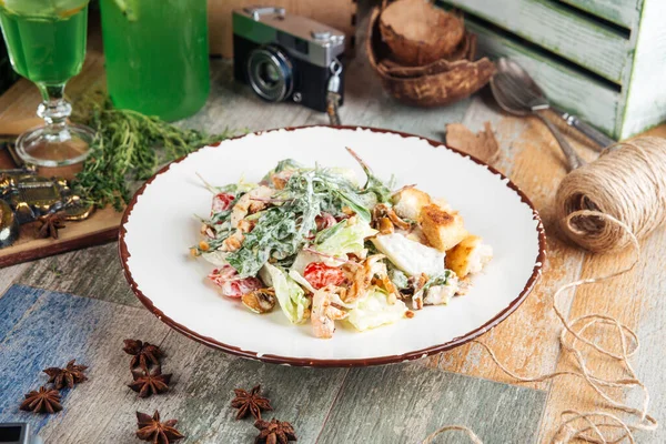 Appetizing caesar salad on the wooden table — Stock Image Appetizing caesar salad on the wooden table Royalty Free Stock Images