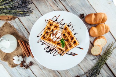 Belgian waffles poured ice cream chocolate syrup