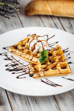Belgian waffles with ice cream and chocolate syrup