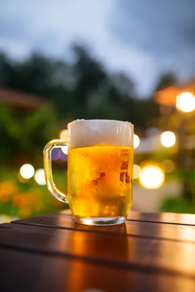 Beer foam outside with blurry lights background — Stock Photo, Image