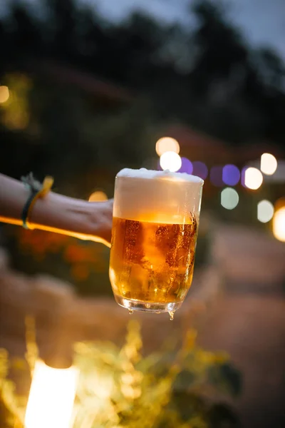 Beer foam outside with blurry lights background — Stock Photo, Image