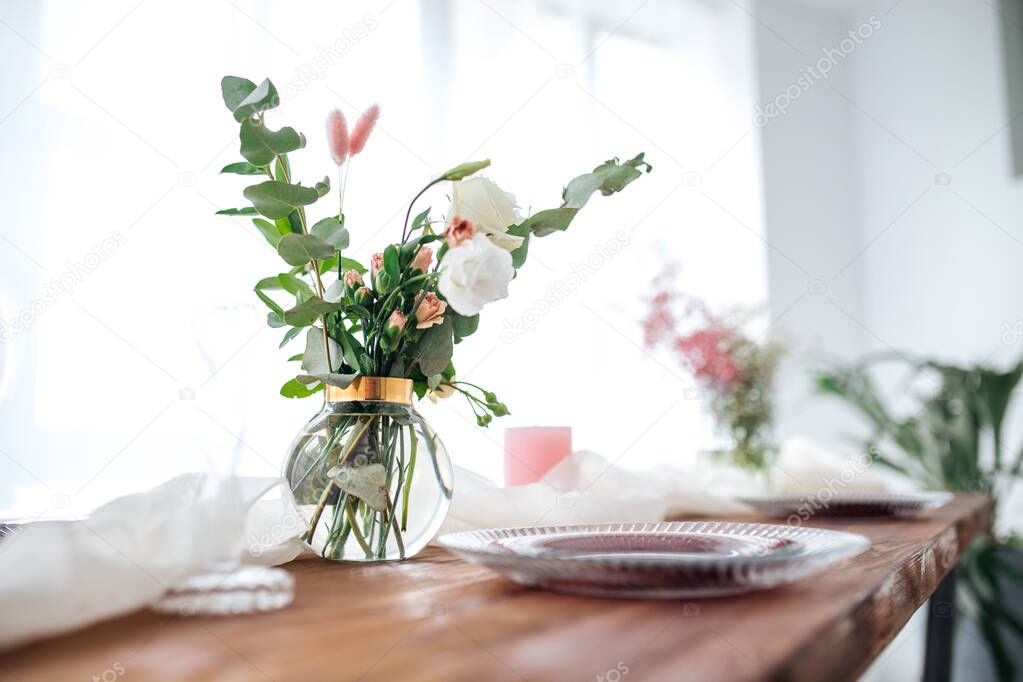 Romantic decorated wooden table with flowers 