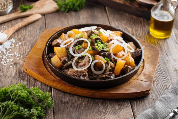 Rustic roasted potatoes and beef in a pan — Stock Photo, Image