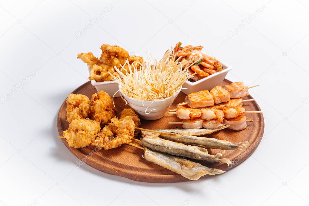 Isolated fried beer platter with fish and shrimps