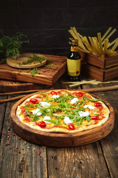 Pizza with tomatoes mozzarella cheese and arugula