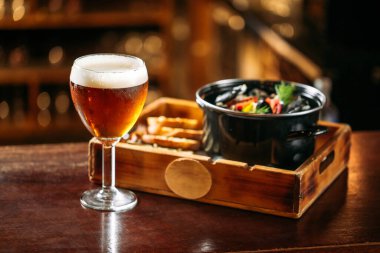 Midyeli bir bardak altın bira.