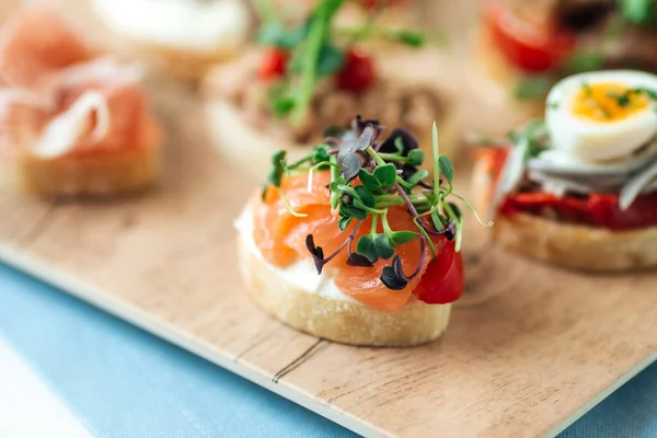Closeup on assorted tapas with different toppings — Stock Photo, Image