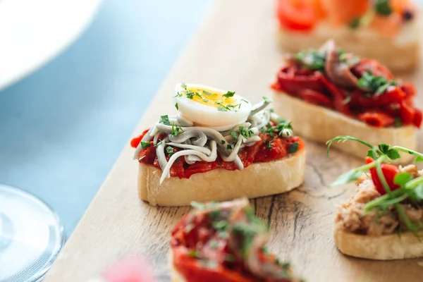 Closeup on assorted tapas with different toppings — Stock Photo, Image