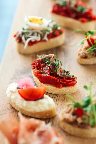 Closeup on assorted tapas with different toppings — Stock Photo, Image