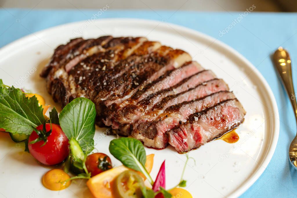 Ribeye beef steak with fresh vegetable salad