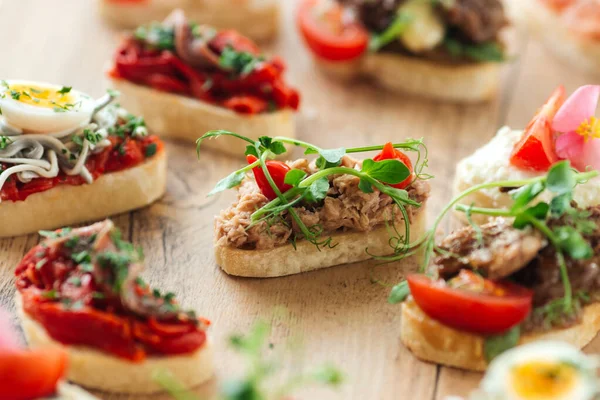 Assorted spanish tapas with different toppings — Stock Photo, Image