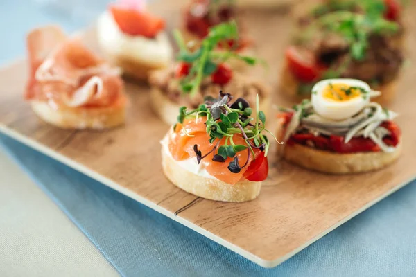 Assorted spanish tapas with different toppings — Stock Photo, Image