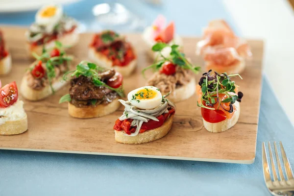 Assorted spanish tapas with different toppings — Stock Photo, Image