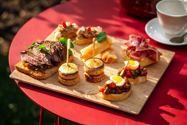 Assorted spanish tapas with different toppings — Stock Photo, Image