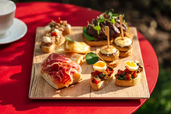 Assorted spanish tapas with different toppings — Stock Photo, Image