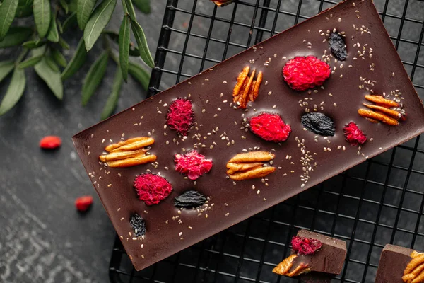 Handmade chocolate bar with pecan and dried berry