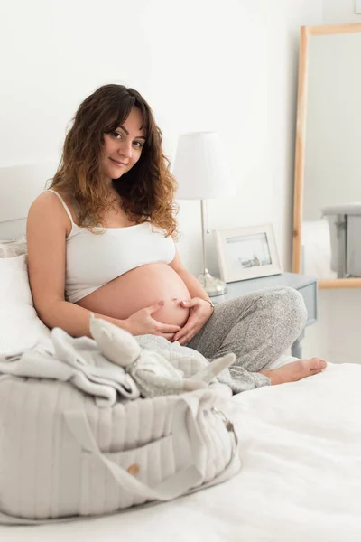 Feliz Mujer Embarazada Sentada Tocando Vientre Casa — Foto de Stock