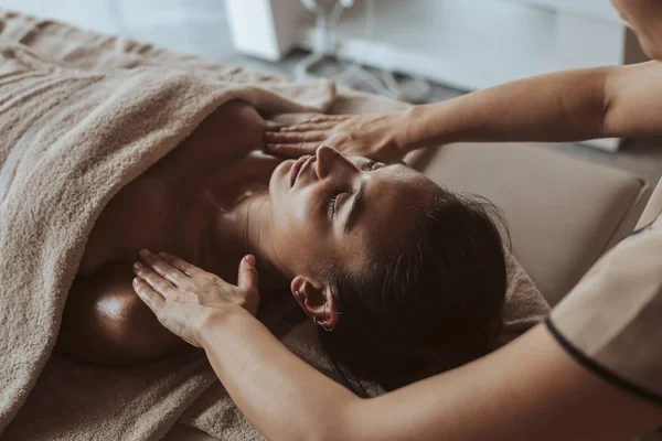 Woman having a facial massage at the spa