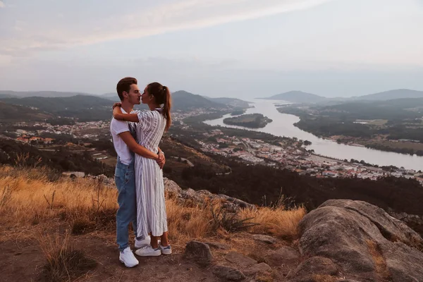 Romantic couple hugging and kissing with a fantastic view