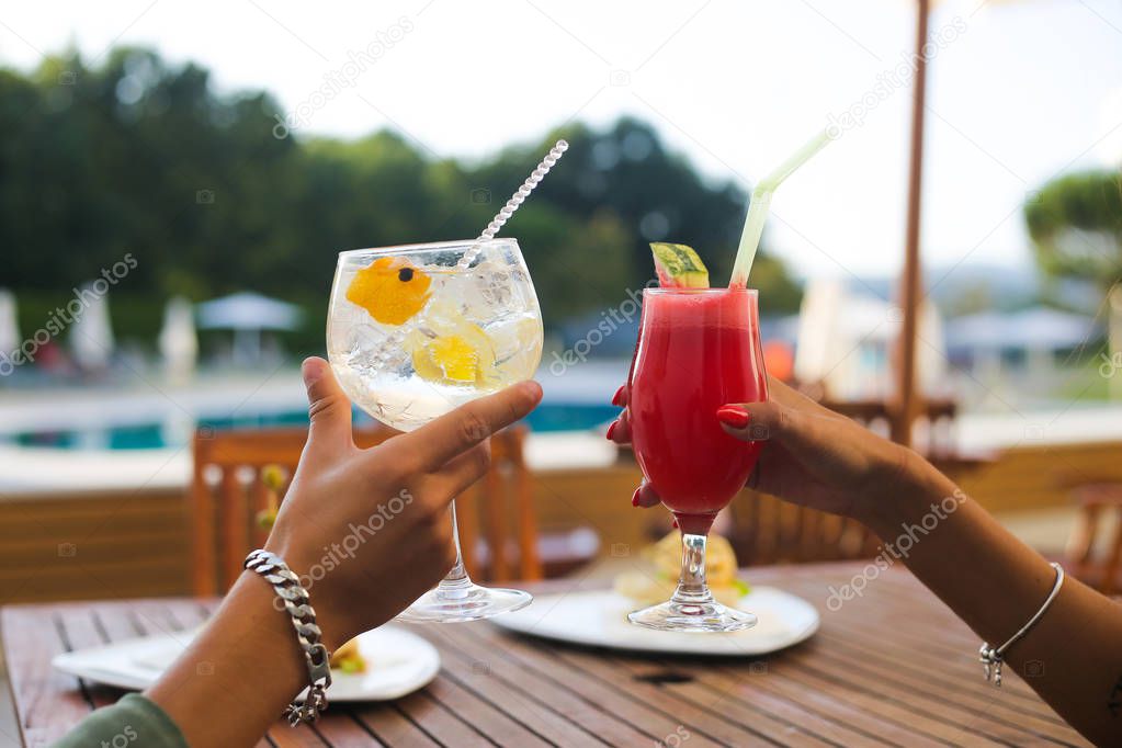 Couple enjoying vacation and drinking cocktails - Spring and Summer
