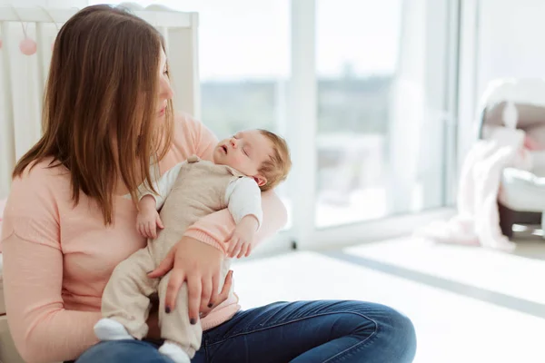 Young Mother holding newborn baby — Stock Photo, Image