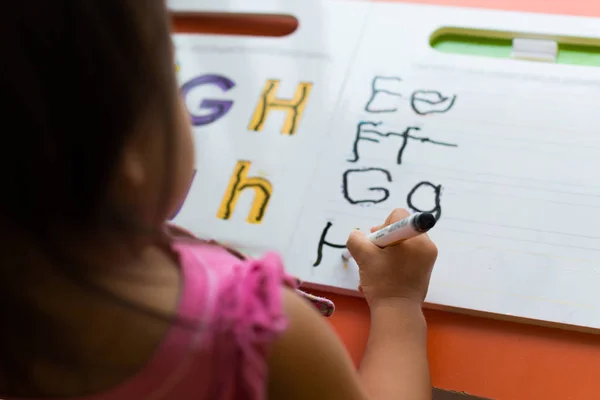 Kids learning how to write the abc's at home. — Stock Photo, Image