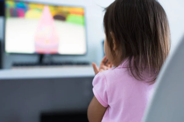 Young child watching tv on the computer at home — 스톡 사진