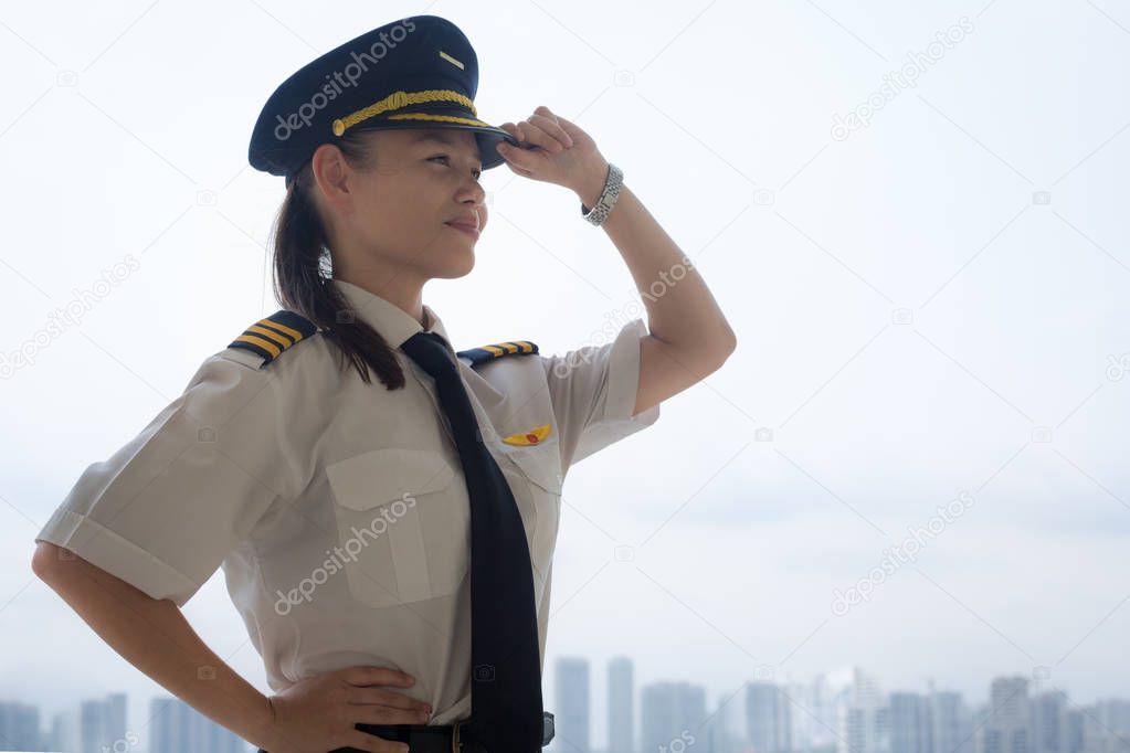 Proud female pilot at the airport.