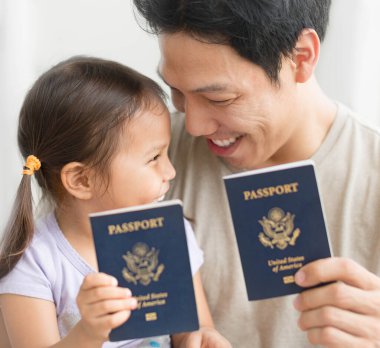 Baba ve kızı Amerika Birleşik Devletleri pasaportlarının alınmasını kutluyorlar.