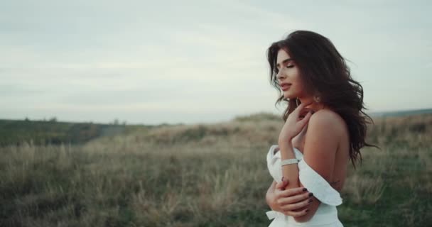 Menina incrível com sorriso perfeito no meio da paisagem close-up sorrindo, vestido com vestido branco — Vídeo de Stock