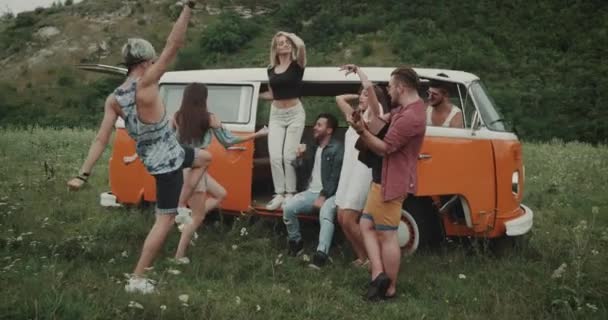 Tiempo de verano de la cadera, los amigos se divierten en medio del paisaje con un autobús retro . — Vídeos de Stock