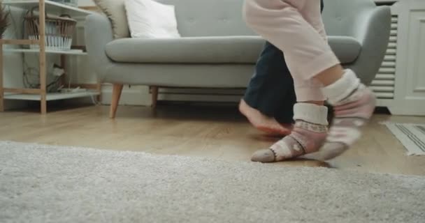 Home style couple dancing in the living room closeup capturing legs. — Stock Video