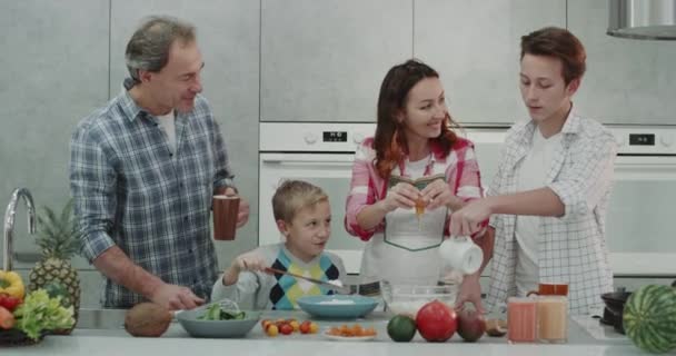 Morgon frukost tillsammans med familjen, laga mat i det moderna köket. — Stockvideo