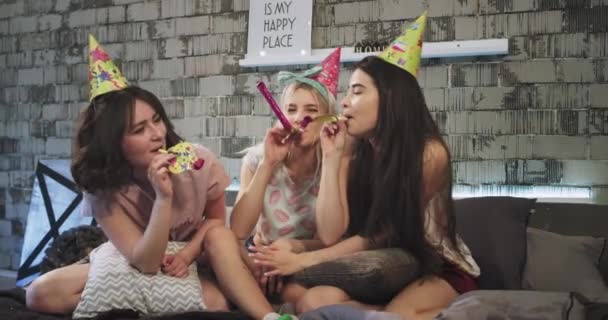 Birthday party celebrating at home sleepover night for group of teenager girls, wearing a birthday hat spending a fun time together using a birthday decorations. — Stock Video