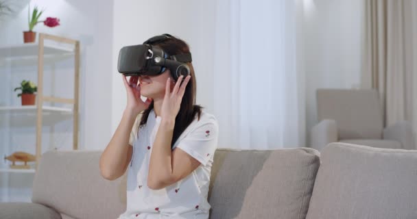 Sorrindo grande mulher carismática usando um óculos de realidade virtual para explorar o mundo, ela está muito impressionada com este novo desenvolvimento tecnológico — Vídeo de Stock